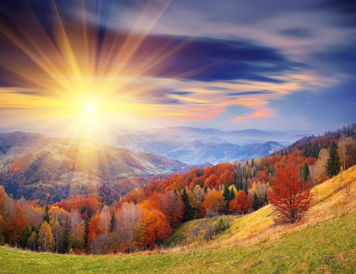 Autumn mountain landscape with sun rays