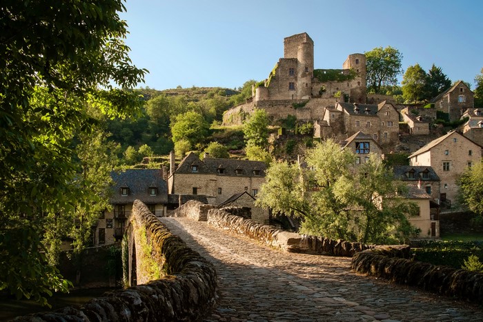 Stone bridge leading to Belcastel village and castle in France
