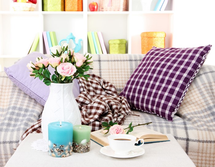 Cozy living room with roses, candles, and books