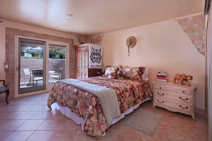 Bedroom with floral bedding and patio doors