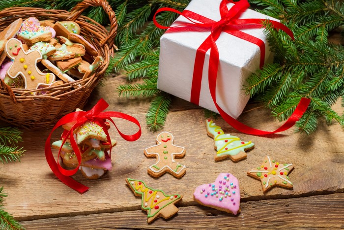 Christmas cookies in a basket with a gift and pine branches