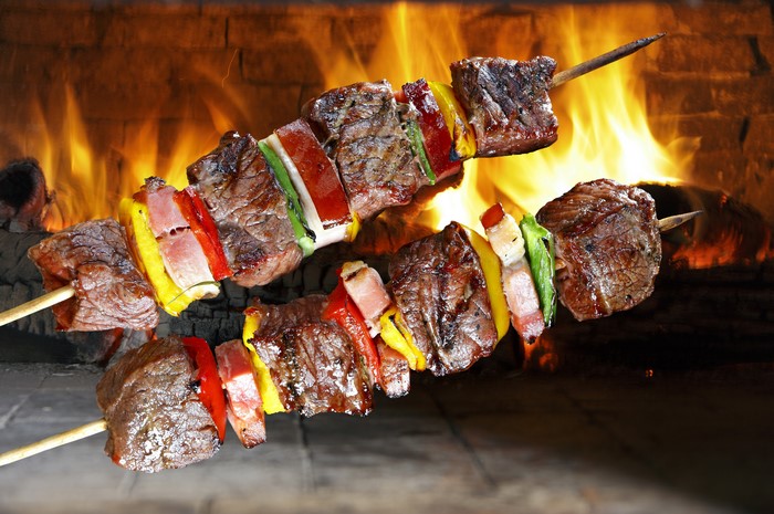 Meat shashlik skewers cooking over a fire