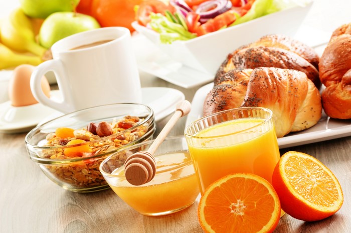 Breakfast with Muesli, Pastries, Juice, and Coffee