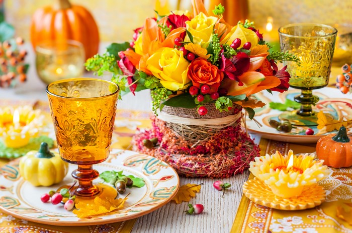 Thanksgiving table setting with flowers and pumpkins