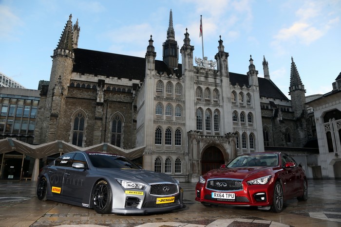 Two Infiniti Q50 NGTC cars in front of a historic building