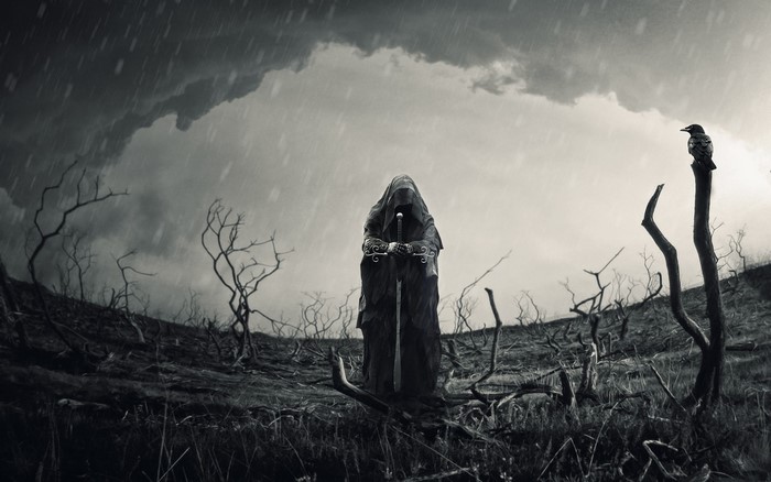 Grim figure with sword in desolate landscape
