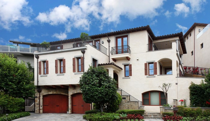 Luxury Mediterranean-style house with garage and landscaping