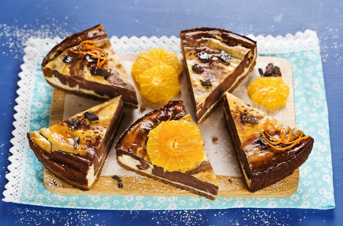 Chocolate orange cheesecake slices with orange slices