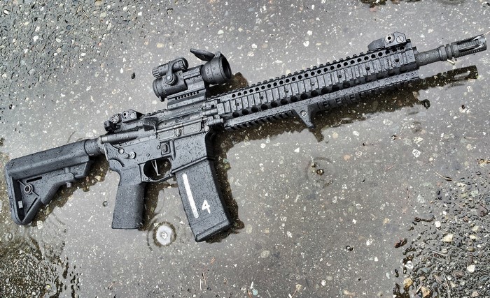 AR-15 style rifle with optics and magazine
