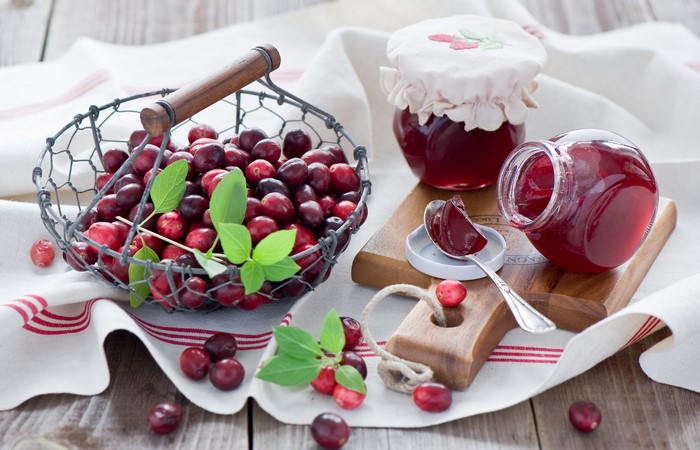 Cranberry jam in jars with fresh cranberries