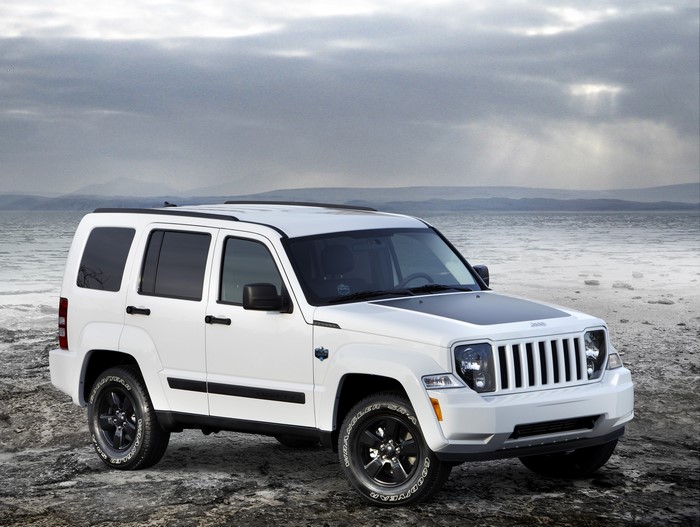 White Jeep Liberty Arctic on a rocky coast