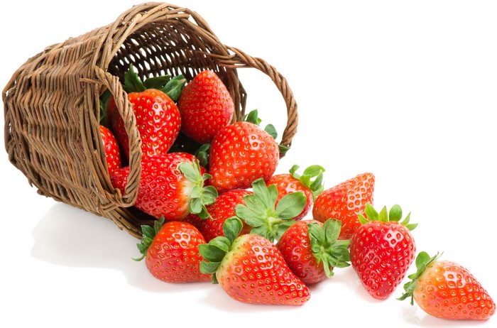 Strawberries spilling from a wicker basket