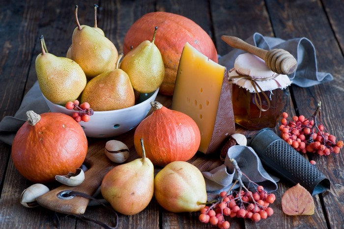 Still-life of pumpkins, pears, cheese, and honey