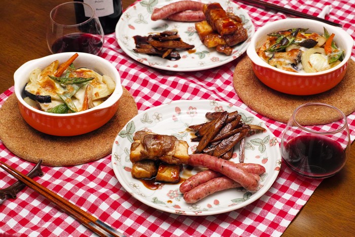 Sausages, Meat, Vegetables, and Wine on a Table