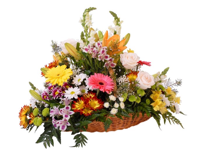 Flower arrangement in a wicker basket with roses, gerberas, and lilies