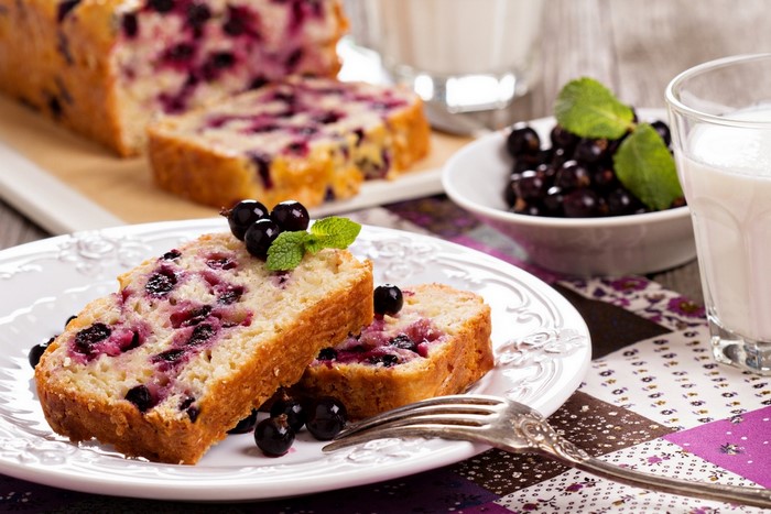 Blackcurrant loaf cake with fresh berries and milk