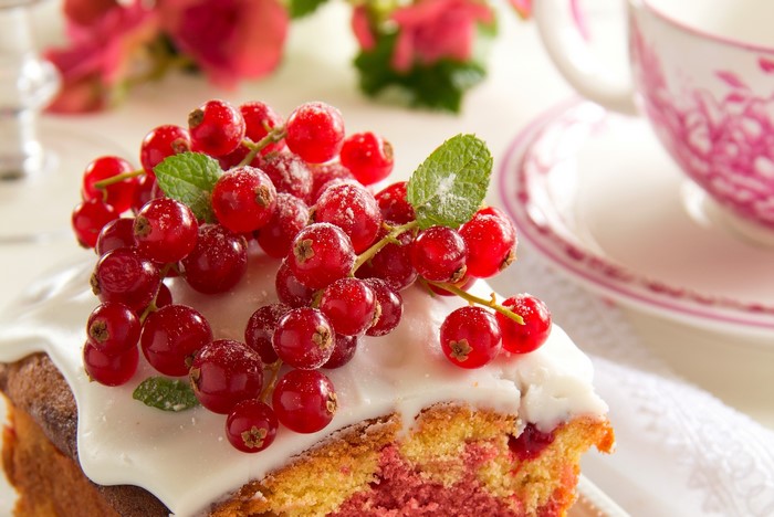 Slice of cake with red currants and mint