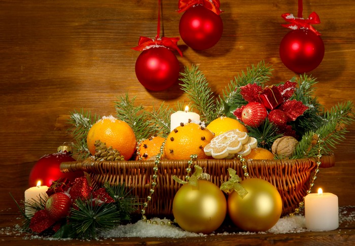 Christmas still life with oranges, candles, and ornaments