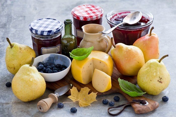 Still life with pears, blueberries, cheese, and jam
