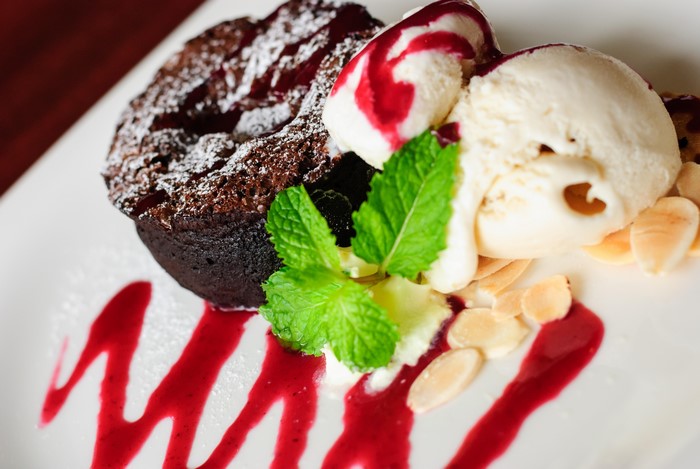 Chocolate lava cake with ice cream and berry sauce