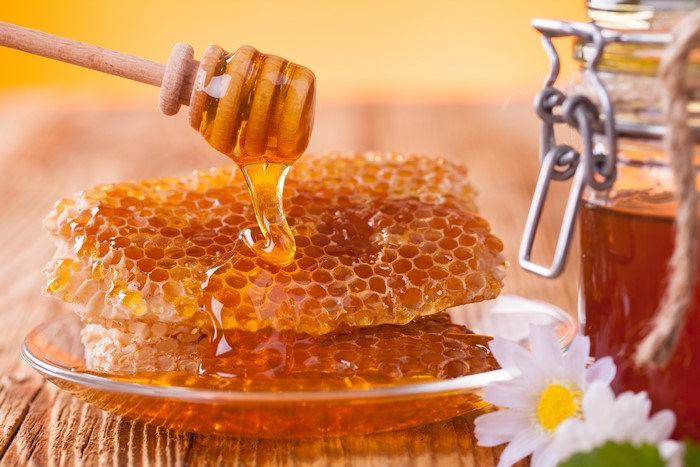 Honeycomb with honey and a jar of honey