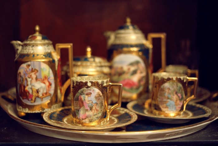 Antique porcelain tea set with painted scenes