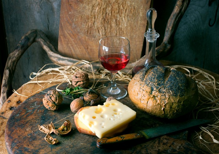 Still-life with cheese, bread, wine, and walnuts