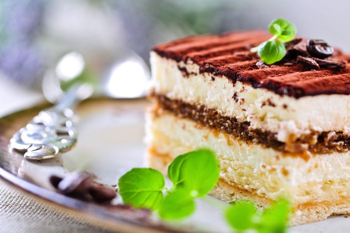 Tiramisu cake with cocoa powder and mint