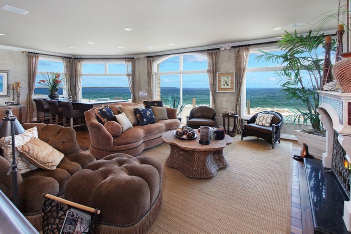 Living room with ocean view, sofa, table, armchair