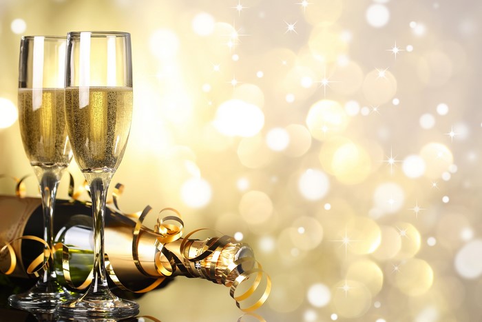 Champagne bottle and glasses with festive bokeh