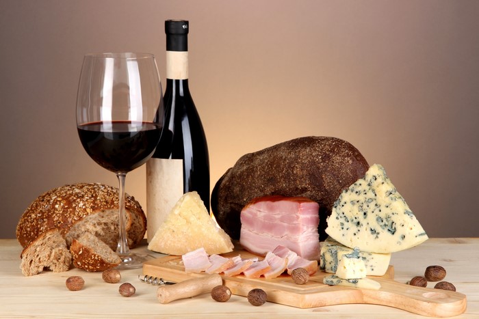 Still-life with wine, bread, cheese, and ham