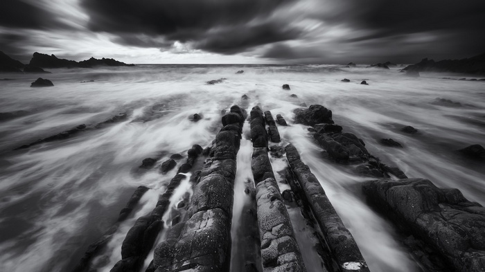 Long exposure of waves crashing on rocky shore