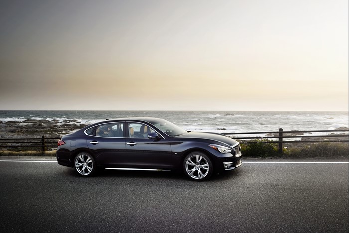 Black Infiniti Q70L parked by the ocean