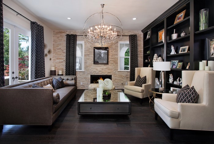 Living room with sofa, armchair, chandelier, and fireplace