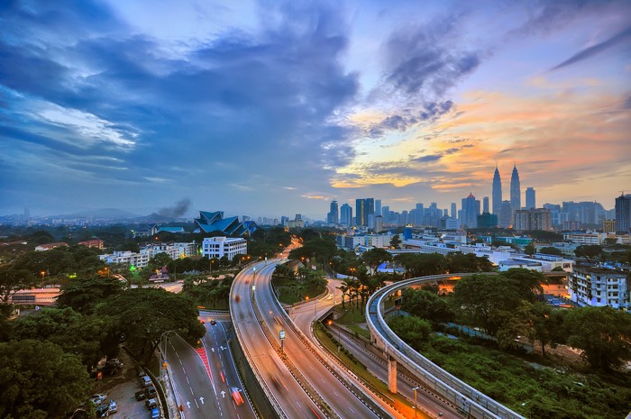 Kuala Lumpur skyline with highways at dusk