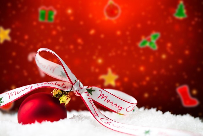 Christmas ornament with ribbon on snow