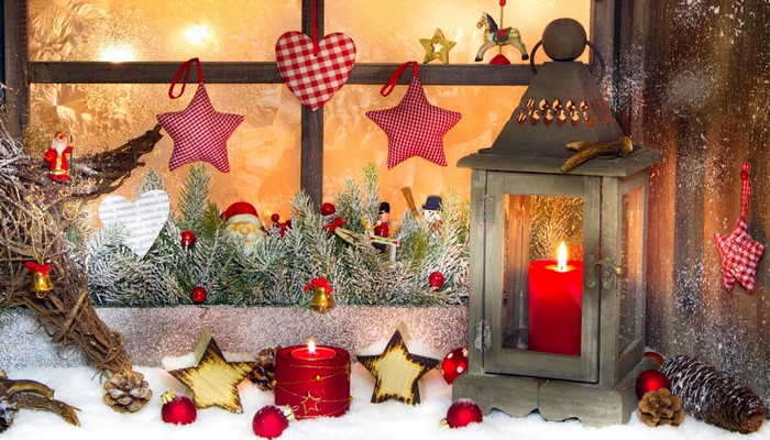Christmas window decoration with candles and ornaments
