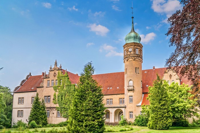 Ulenburg Castle in Germany with Spruce Trees