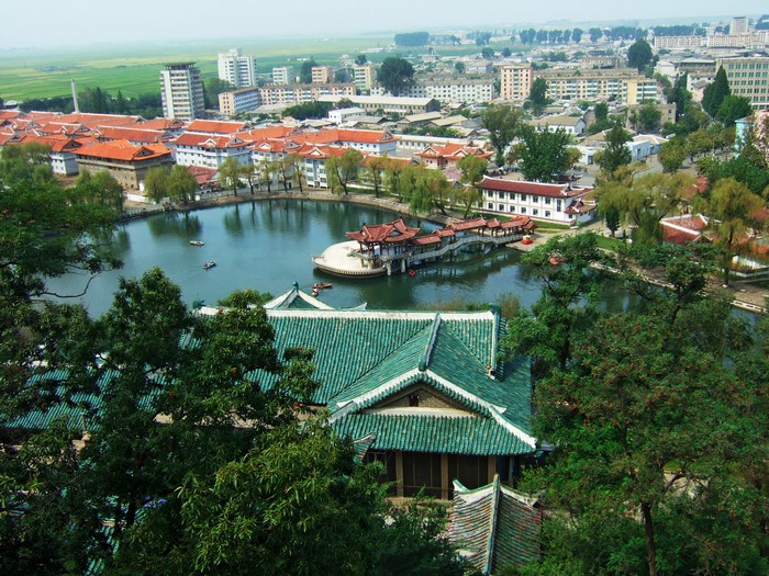 Cityscape with lake and traditional buildings