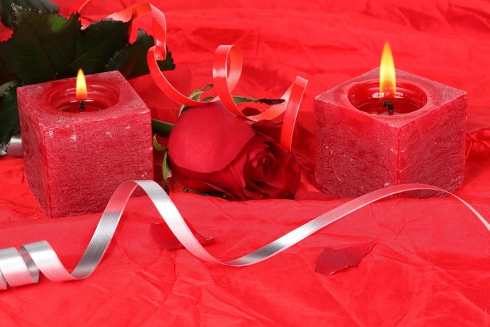 Red candles and rose with ribbons