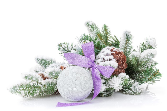 Christmas decoration with pine cones, branches, and a silver ball with a purple bow