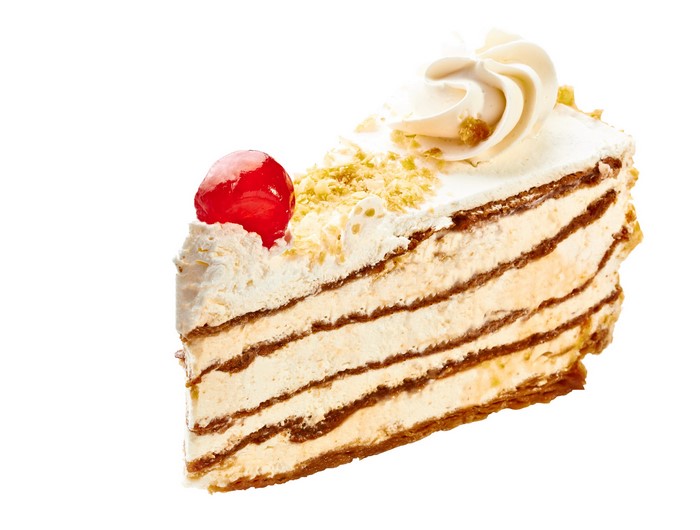 Slice of layered cake with cream and cherry