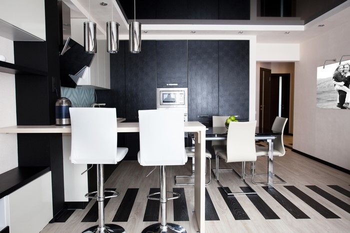 Modern kitchen and dining area with black and white design