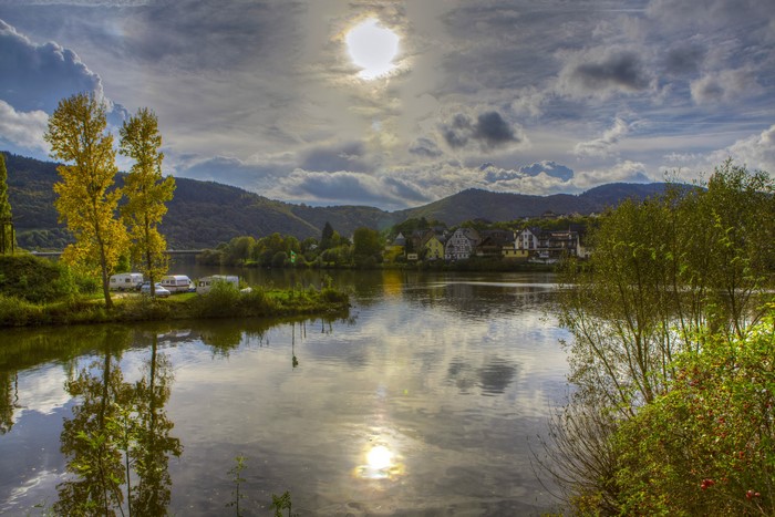 River with trees and village in Ulmen, Germany