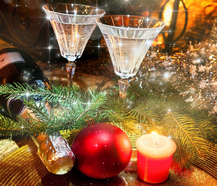 Champagne glasses with Christmas decorations and candle