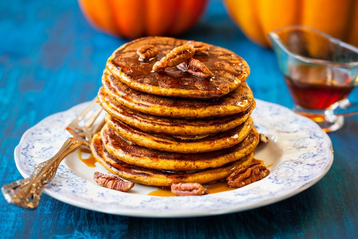 Stack of Pumpkin Pancakes with Pecans and Syrup