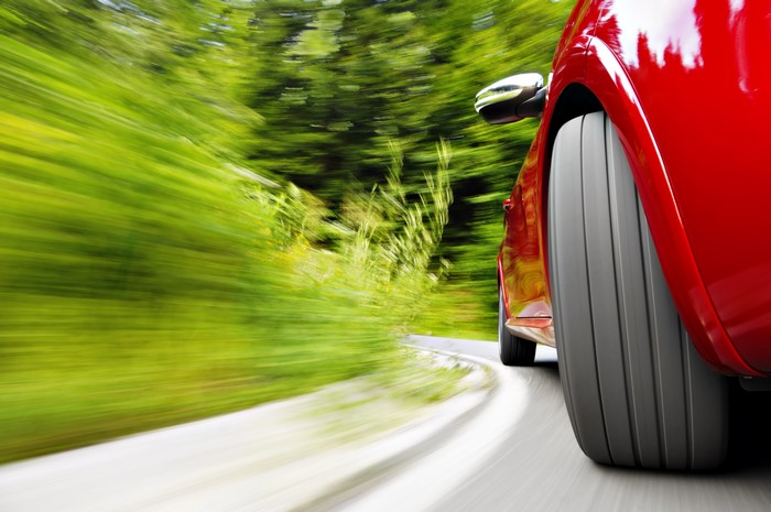 Red car driving on a winding road