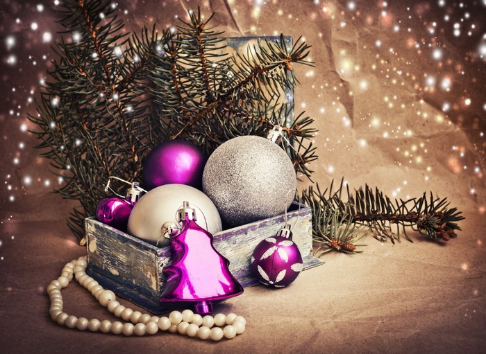 Christmas ornaments in a wooden box with pine branches