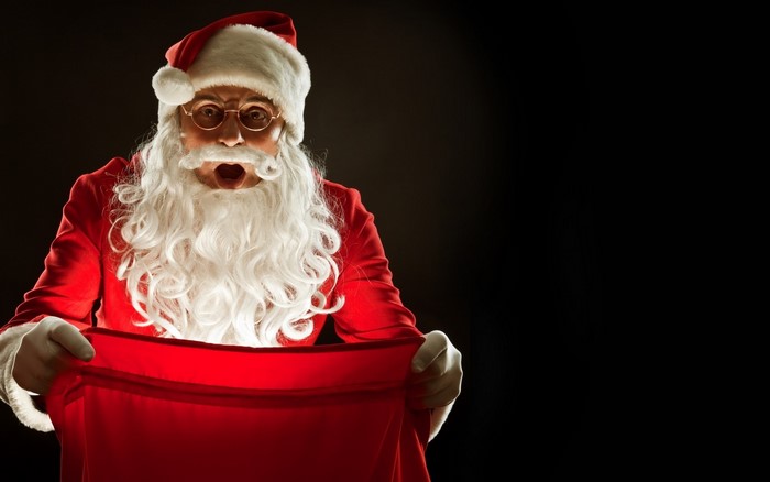 Santa Claus looking into a red sack