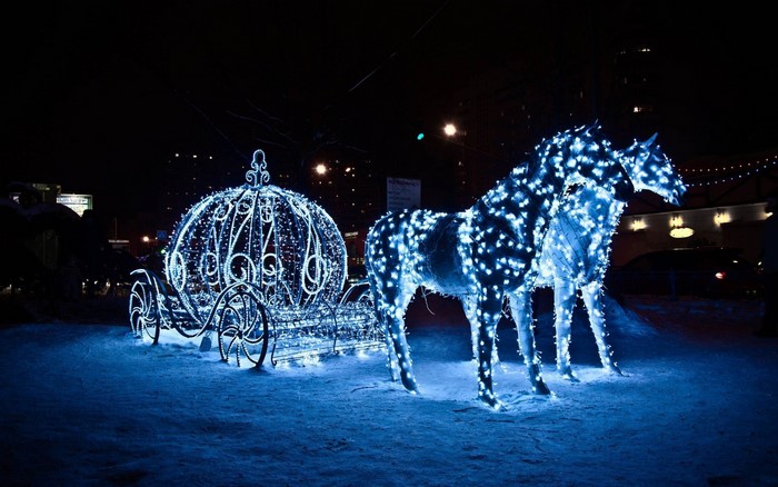 Cinderella carriage and horses illuminated with blue lights